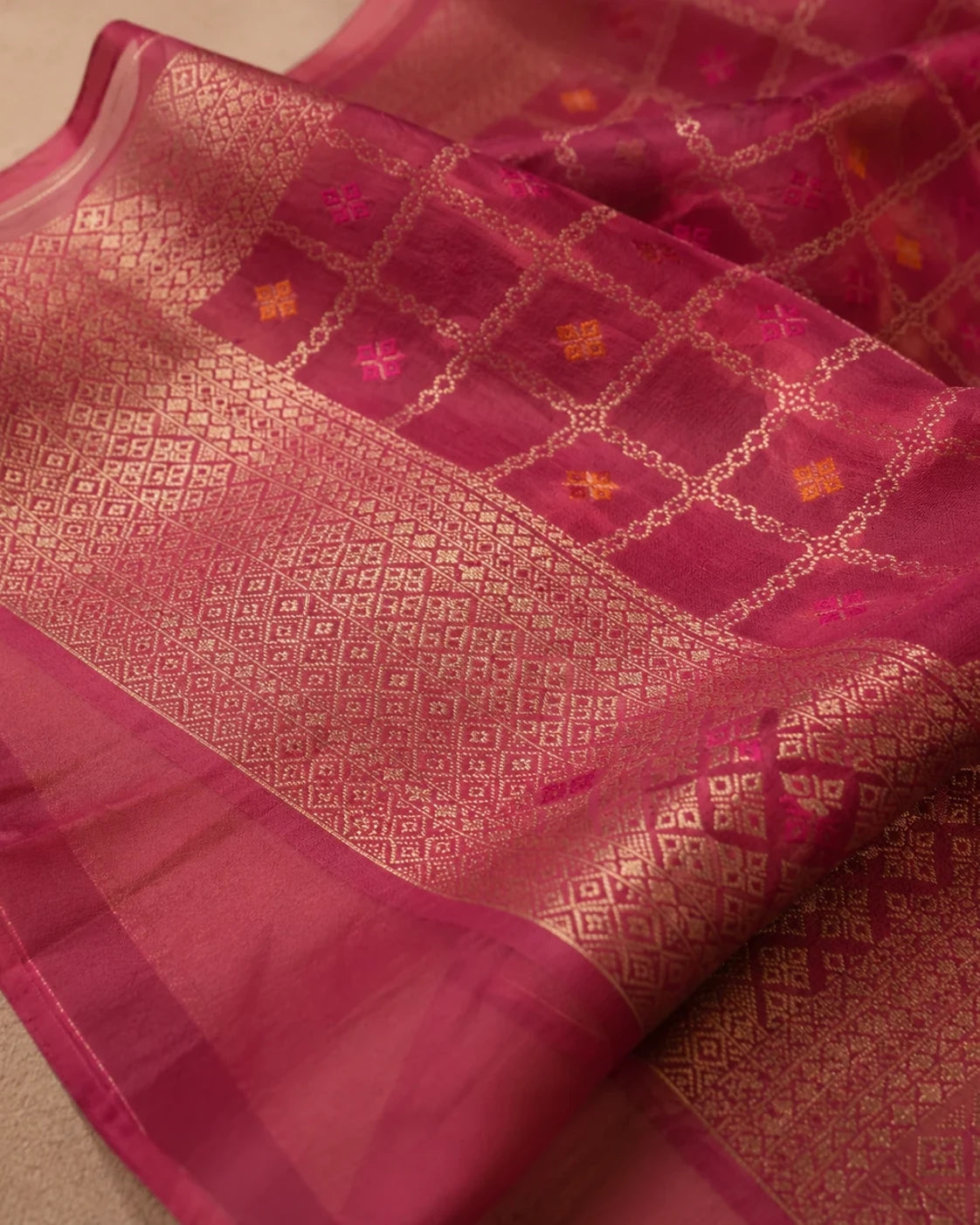 Close-up of deep magenta Banarasi dupatta with gold woven motifs and decorative border